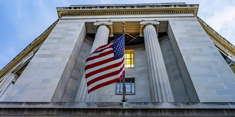 Facade FlagsJustice Department Building Pennsylvania Avenue Washington DC Completed in 1935. Houses 1000s of lawyers working at Justice.